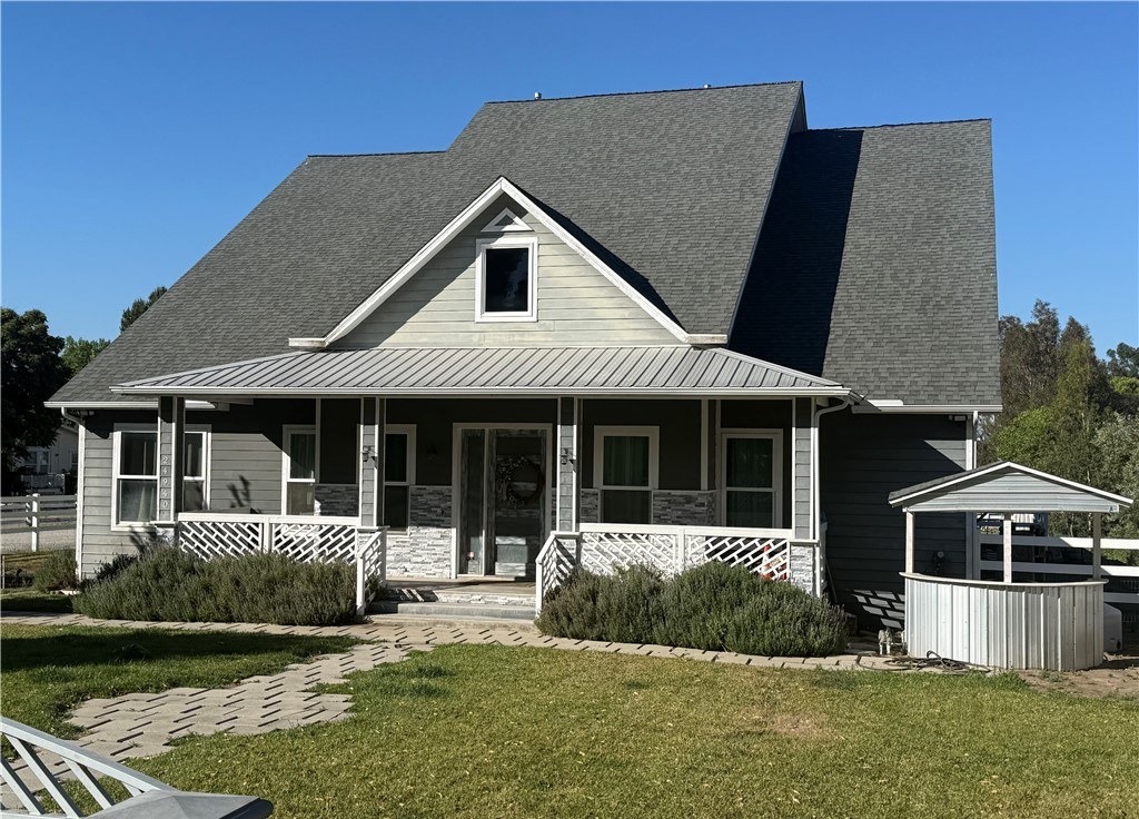 Custom craftsman estate in Murrieta with a wraparound porch and metal roof